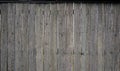 The texture of an old rustic wooden fence made of flat processed boards. Detailed image of a street fence of a rustic type made o Royalty Free Stock Photo