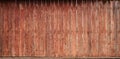 The texture of an old rustic wooden fence made of flat processed boards. Detailed image of a street fence of a rustic type made o