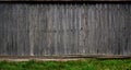 The texture of an old rustic wooden fence made of flat processed boards. Detailed image of a street fence of a rustic type made o Royalty Free Stock Photo