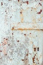 Texture of old rusty metal with keyhole, painted white which became orange from rust in some places. Horizontal texture of cracked