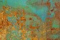 Texture of rusty metal, painted green which becames orange from rust. Horizontal texture of cracks and peels paint on rusty steel Royalty Free Stock Photo