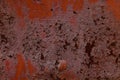 Texture of old rusty metal wall covered by old damaged red paint Royalty Free Stock Photo