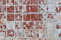 Texture of an old square tile on a wall with peeling ocher paint Royalty Free Stock Photo