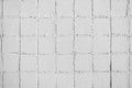 Texture and old square tiles of beige white color tile wall Royalty Free Stock Photo