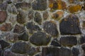 The texture of the old stone wall of large cobblestones overgrown with moss Royalty Free Stock Photo