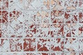 Texture of an old square tile on a wall with peeling ocher paint Royalty Free Stock Photo