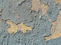 A layer of peeling old blue paint on the relief surface of a concrete cement wallTexture of old white cracked paint on blue concre Royalty Free Stock Photo