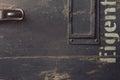 Texture of an old wooden case for military equipment with metal fittings and a part of a stencilled german word