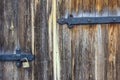 Texture of an old wooden gate with a large lock.