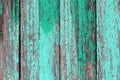 Texture of old wooden planks with cracked green paint