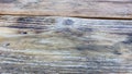 Texture of old wooden shabby planks with cracks and stains. Abstract background of wooden table top 