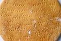 The texture of one round baked layer of honey cake