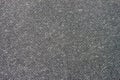 Texture of organic dark grey paper for artwork with numerous natural inclusions. Modern dark background, backdrop