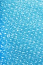 Packing bubble wrap for parcels on a blue background in full screen Royalty Free Stock Photo