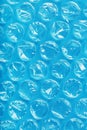 The texture of the packaging air-bubble film on a blue background in full screen Royalty Free Stock Photo