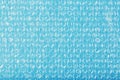 The texture of the packaging air-bubble film on a blue background in full screen Royalty Free Stock Photo
