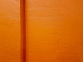 Texture of a painted orange concrete wall with a corner ledge. Royalty Free Stock Photo