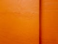 Texture of a painted orange concrete wall with a corner ledge. Royalty Free Stock Photo