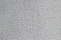 Texture of painted in white decorative plasterwork on a sunny day as a background Royalty Free Stock Photo