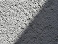 Texture of a part of a gray concrete wall with shadow