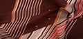 Texture, pattern, collection, silk fabric, brown background with a striped pattern of white and red lines, the Spanish theme, Royalty Free Stock Photo