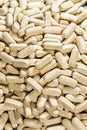 Texture of a pile of oval medical pills or dietary supplements.