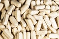 Texture of a pile of oval medical pills or dietary supplements.