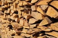 Texture of pine firewood. Chipped firewood is on the heap. Woodpile of firewood close-up. A stack of dry firewood, visible texture