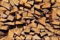 Texture of pine firewood. Chipped firewood is on the heap. Woodpile of firewood close-up. A stack of dry firewood, visible texture