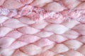 Texture of pink big knit blanket. Large knitting. Plaid merino wool. Top view Royalty Free Stock Photo