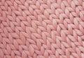 Texture of pink knit blanket. Large knitting. Plaid merino wool. Top view