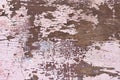 Texture of pink flaking paint on brown wooden surface. Background, wallpaper, close-up, top view. Royalty Free Stock Photo