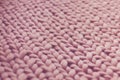 Texture of pink knit blanket. Large knitting. Plaid merino wool. Royalty Free Stock Photo