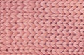 Texture of pink knit blanket. Large knitting. Plaid merino wool. Top view Royalty Free Stock Photo