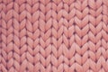 Texture of pink knit blanket. Large knitting. Plaid merino wool. Top view Royalty Free Stock Photo