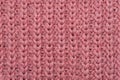 Texture of a pink knitted sweater close up, red knitted wool Royalty Free Stock Photo