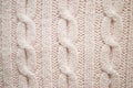 Texture of pink knitted sweaters ornament. Chain Cable stitch knit fabric background closeup, soft focus Royalty Free Stock Photo