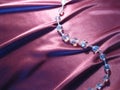 Texture of pink silk with crystal beads.