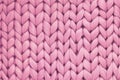 Texture of pink wool big knit blanket. Large knitting. Plaid merino wool. Top view Royalty Free Stock Photo