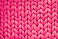 Texture of pink wool big knit blanket. Large knitting. Plaid merino wool. Top view Royalty Free Stock Photo