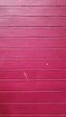 Stock Photo - Old building with red and pink background on cement wall surface. Royalty Free Stock Photo