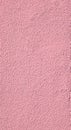 Texture of a plasterwork painted in pink used as an exterior coating on a building