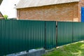 Texture of profiled metal. Metal fence. Green metallic corrugated fence Royalty Free Stock Photo