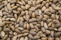 Texture of raw unshelled almonds, top view. Almond nuts background