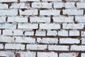 The texture of red brick painted with white cracked paint. Old wall. Royalty Free Stock Photo