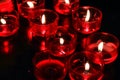 Red Candles lit by prayers in a church Royalty Free Stock Photo