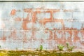 Texture of red fluted brick wall with white peeling paint