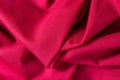 Texture of red cotton fabric with arbitrary bends and wave, abstract background Royalty Free Stock Photo