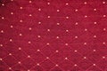Texture of red fabric with rombic pattern with white dot