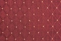 Texture of red fabric with rombic pattern with white dot